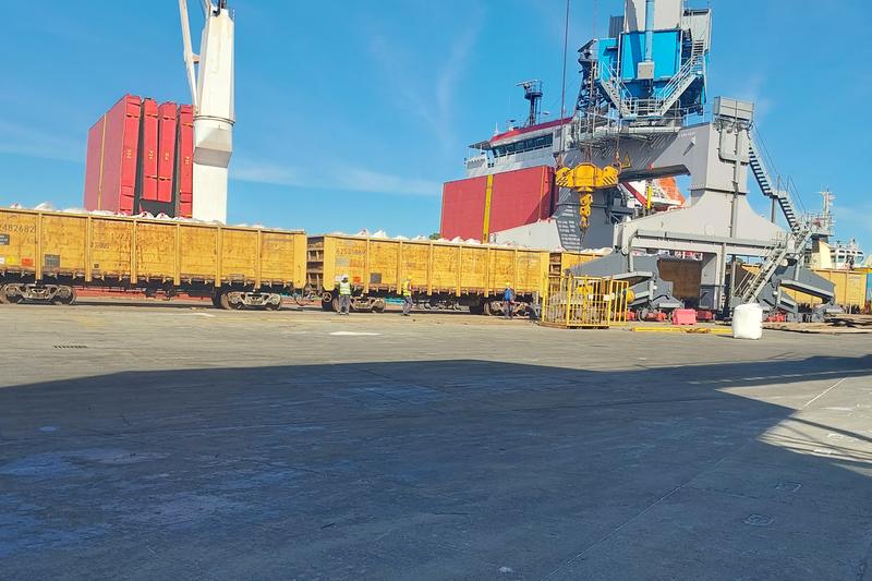 Rail wagons on a quay beside a ship
